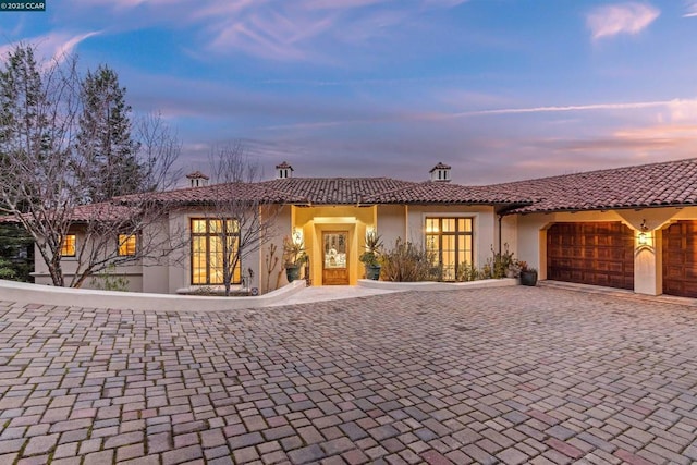 mediterranean / spanish house featuring a garage