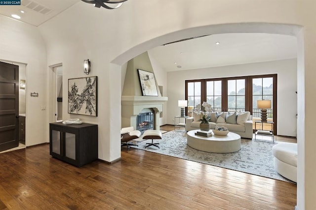 living room with vaulted ceiling and dark hardwood / wood-style floors