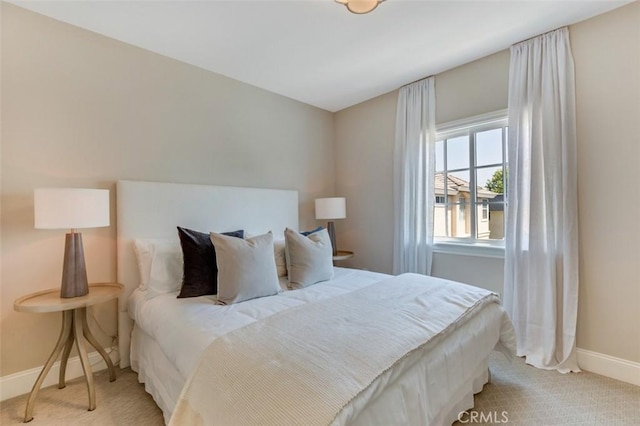 bedroom featuring light carpet