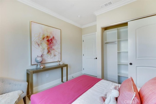 bedroom with crown molding and a closet