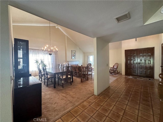 dining space featuring a chandelier, carpet, tile patterned flooring, and a healthy amount of sunlight