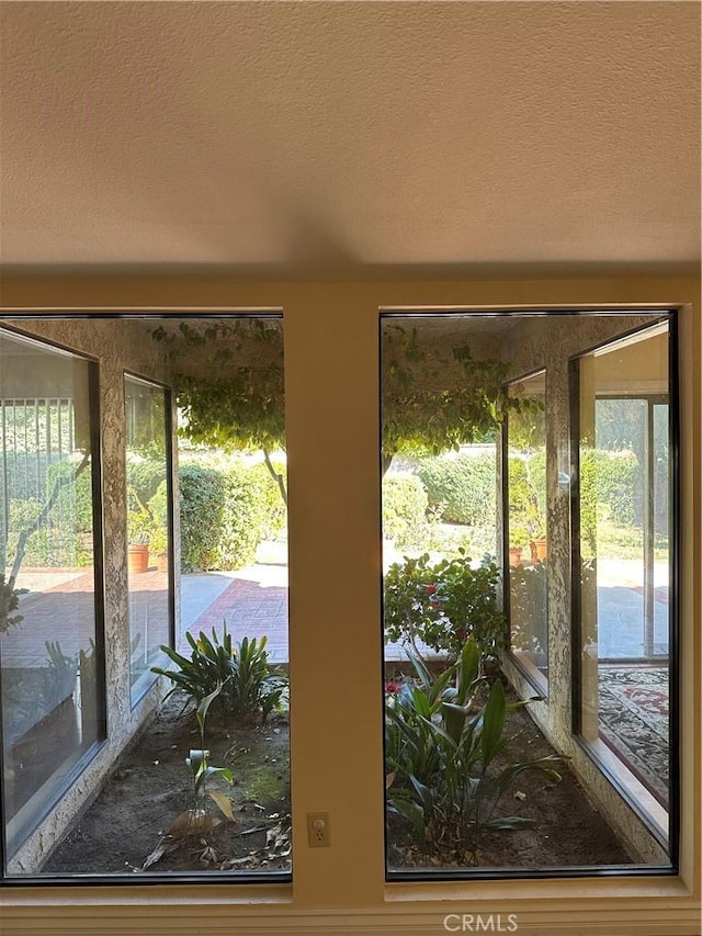 doorway with a textured ceiling