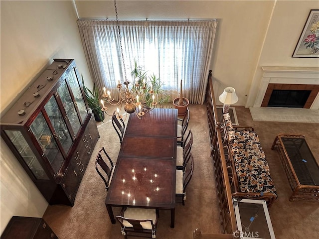 carpeted dining space featuring a fireplace with raised hearth