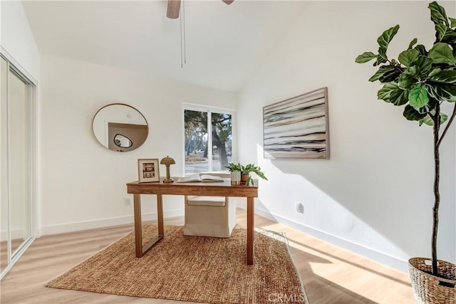 office area featuring ceiling fan, vaulted ceiling, and light wood-type flooring