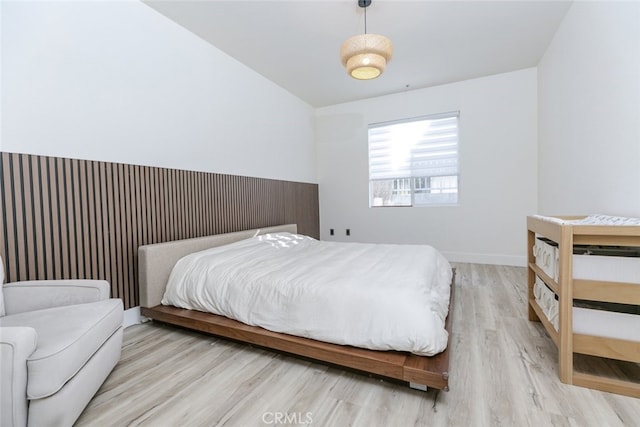 1023 Wilcox Ave Unit 102, Los Angeles, CA 90038 - bedroom featuring wood finished floors and vaulted ceiling