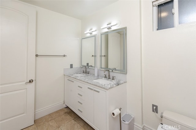 bathroom featuring vanity, tile patterned floors, and toilet