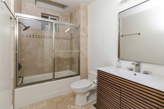 full bathroom with toilet, vanity, and bath / shower combo with glass door