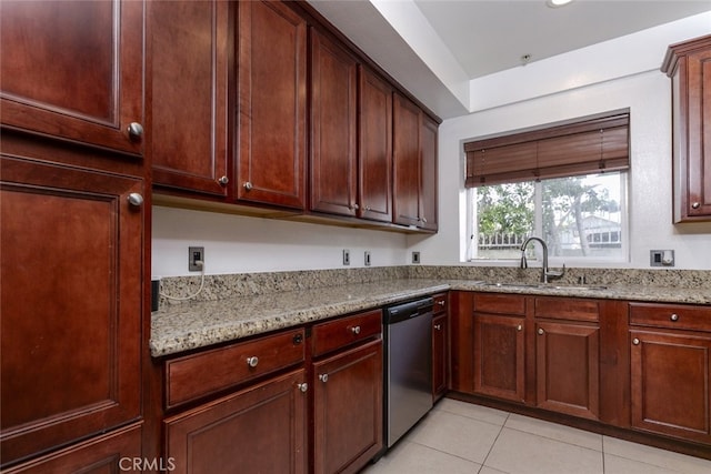 kitchen featuring light stone counters, stainless steel dishwasher, light tile patterned flooring, and sink