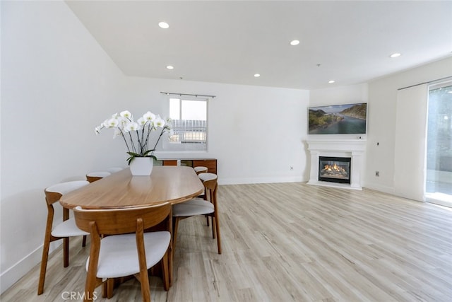 1023 Wilcox Ave Unit 102, Los Angeles, CA 90038 - dining area featuring recessed lighting, a glass covered fireplace, and light wood finished floors