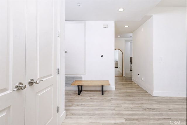 corridor with light hardwood / wood-style flooring