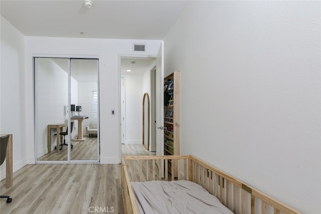 bedroom featuring a closet and light hardwood / wood-style flooring