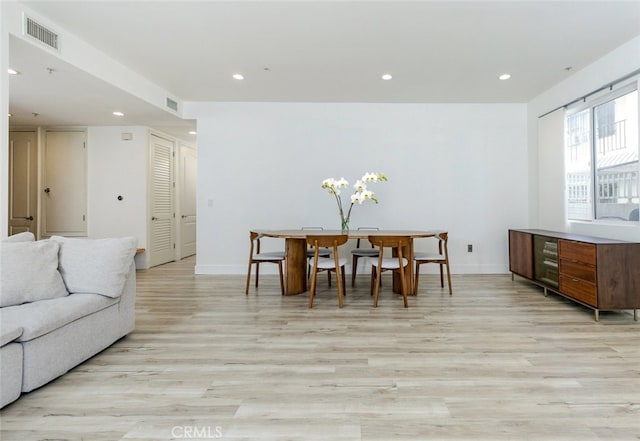 dining space with light hardwood / wood-style flooring