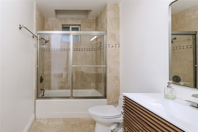 full bathroom with vanity, shower / bath combination with glass door, and toilet