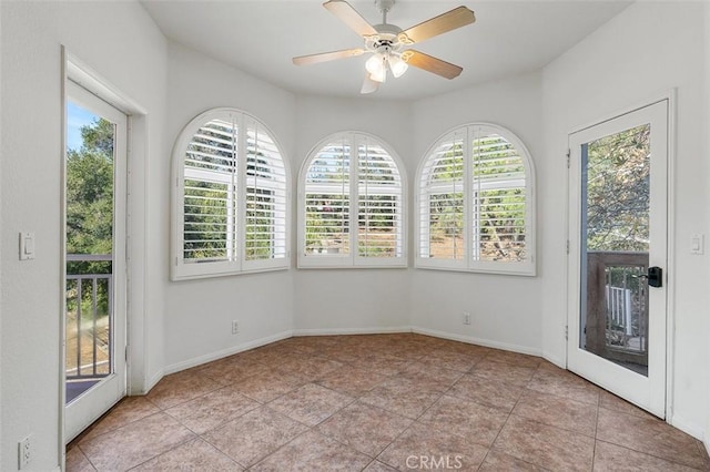 unfurnished sunroom with plenty of natural light and ceiling fan