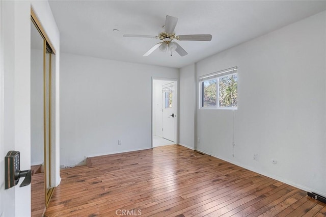 unfurnished bedroom with light hardwood / wood-style flooring, a closet, and ceiling fan