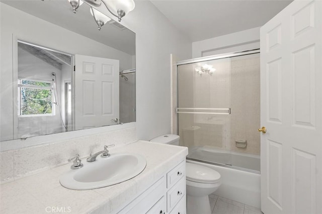 full bathroom featuring tile patterned flooring, vanity, shower / bath combination with glass door, and toilet