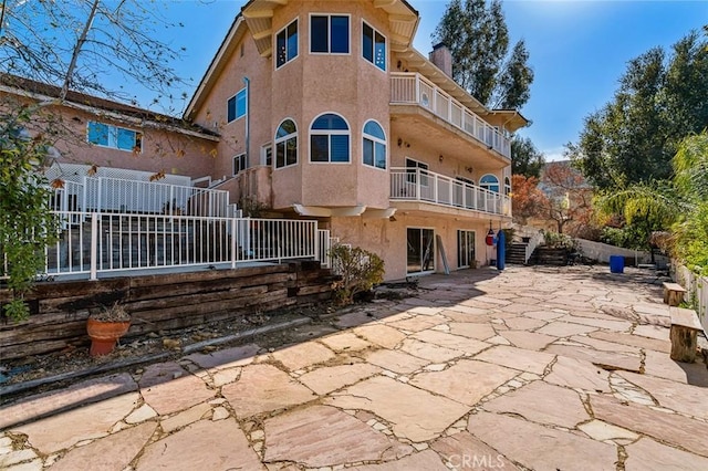 back of house with a patio