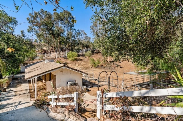 exterior space with an outdoor structure and a rural view