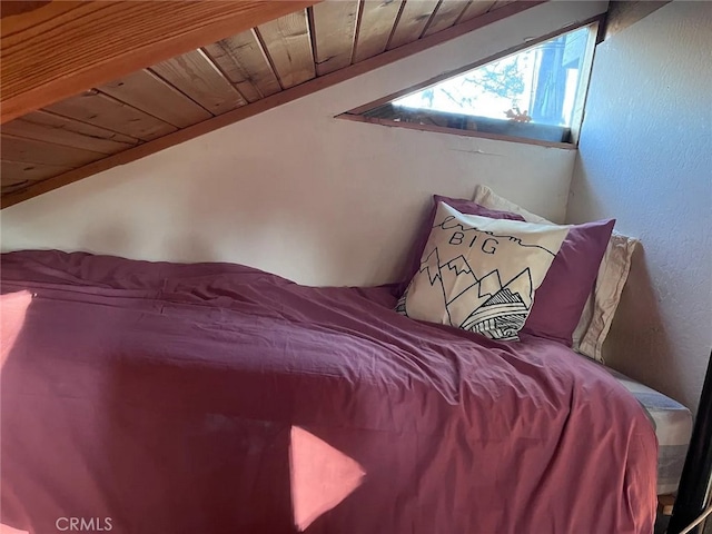 bedroom with lofted ceiling and wooden ceiling