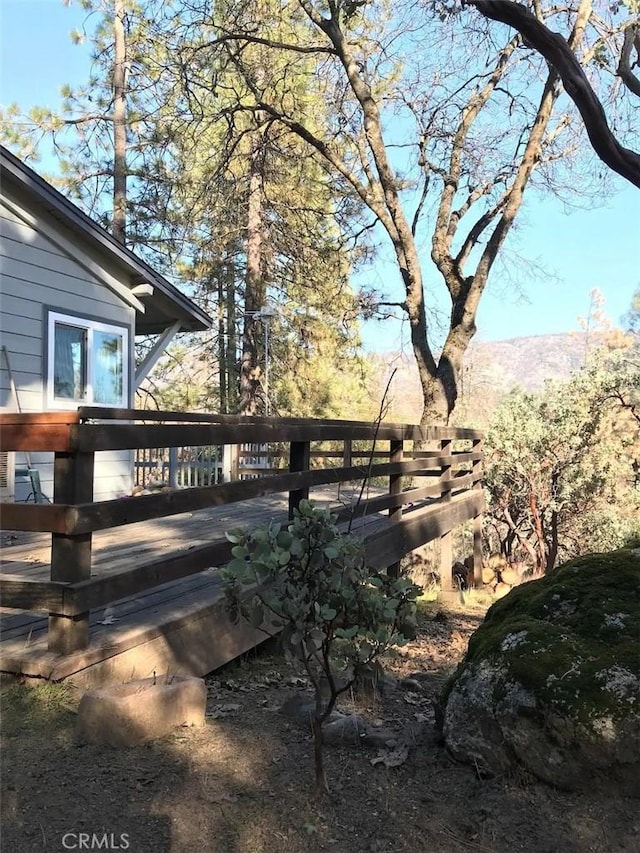 view of yard featuring a deck with mountain view