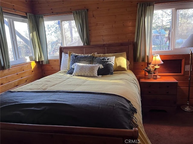 bedroom featuring wood walls