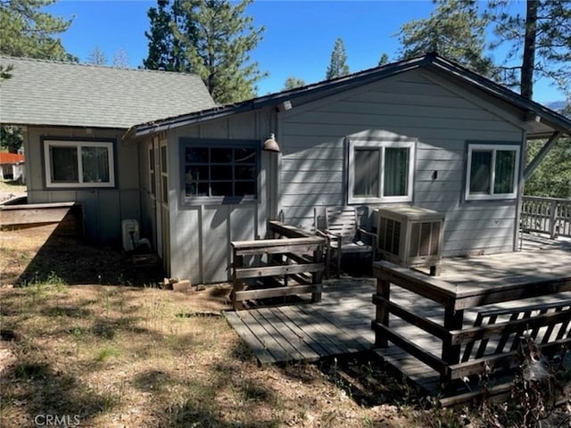 back of house with a wooden deck