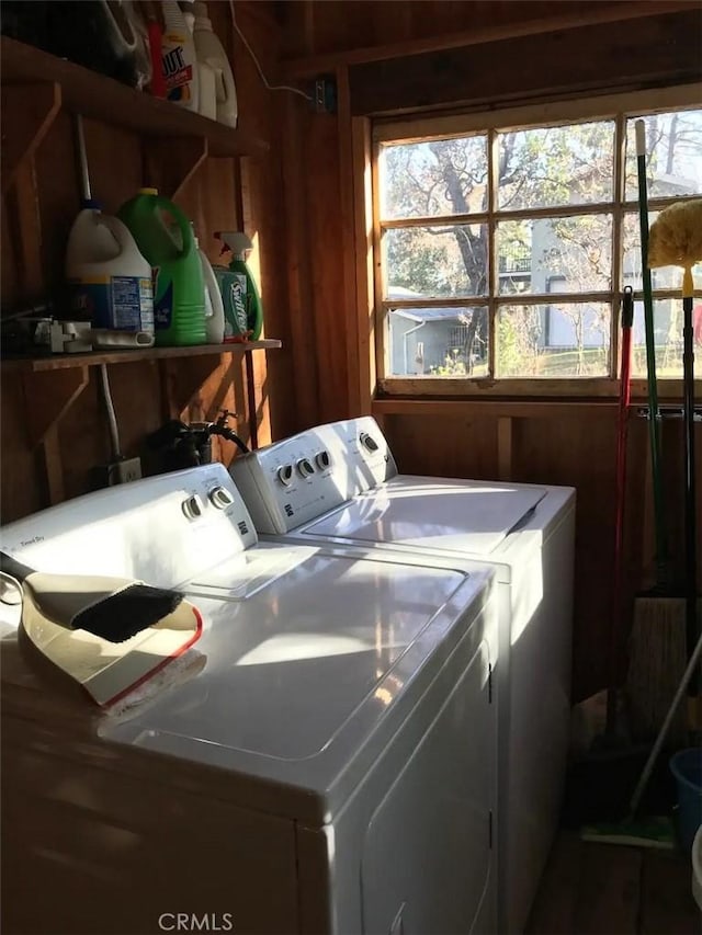 clothes washing area featuring separate washer and dryer