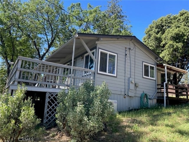 view of side of home with a wooden deck