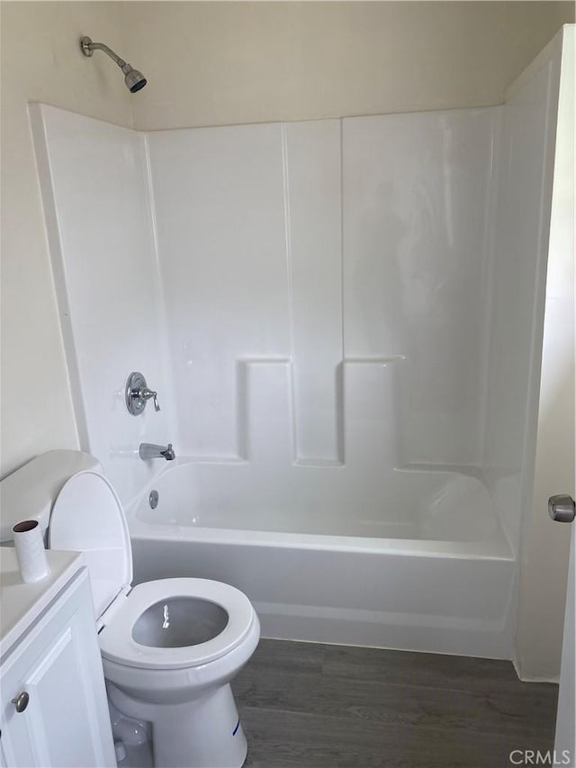 full bathroom with vanity, toilet, bathing tub / shower combination, and hardwood / wood-style floors