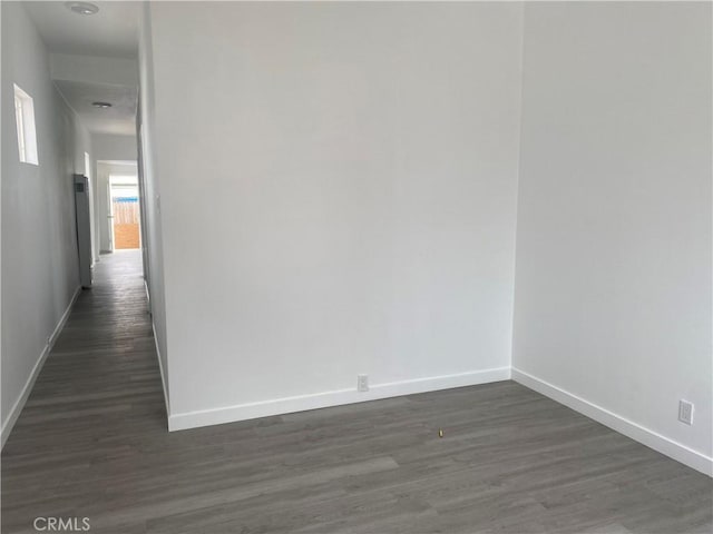 empty room featuring dark hardwood / wood-style flooring