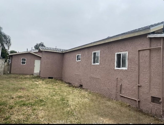 view of side of property with a lawn