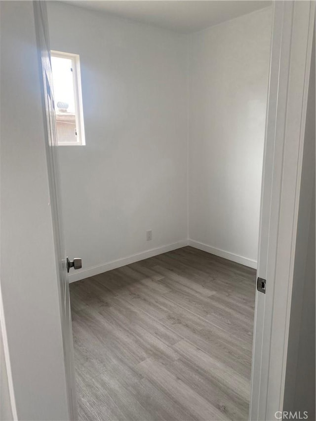 empty room with light hardwood / wood-style flooring