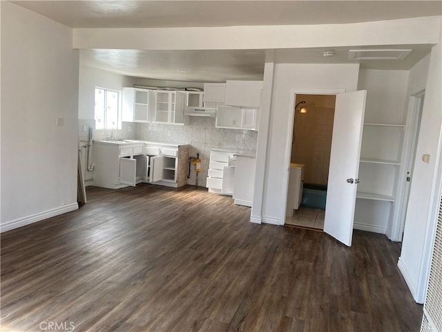 unfurnished living room featuring dark hardwood / wood-style floors and sink