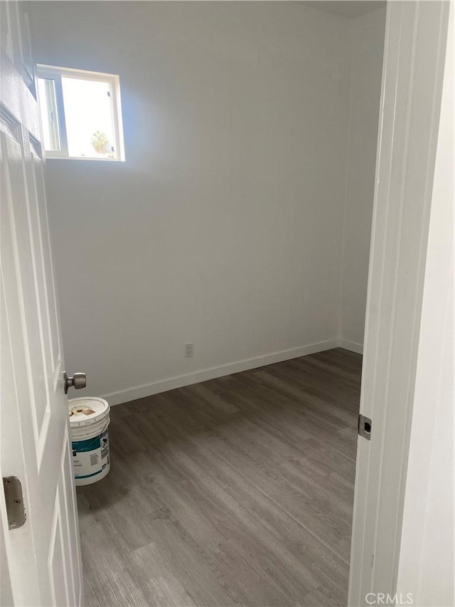 unfurnished room with wood-type flooring