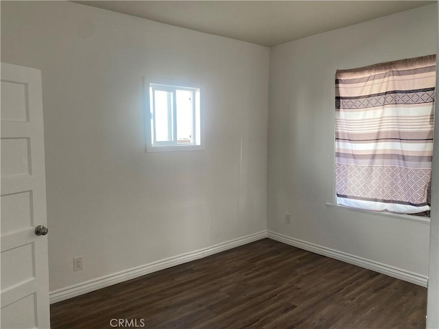 spare room featuring dark hardwood / wood-style floors