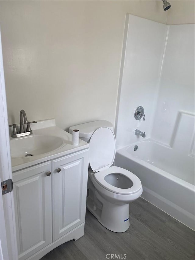 full bathroom featuring vanity, tub / shower combination, hardwood / wood-style floors, and toilet