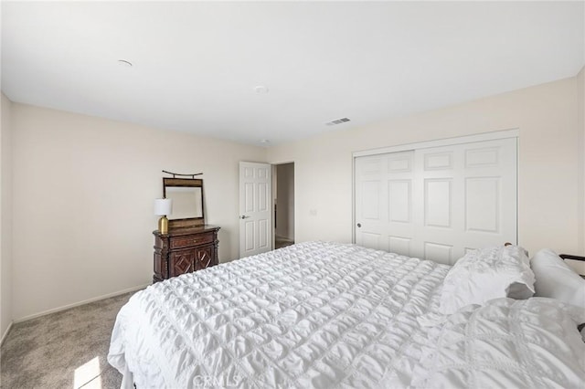 bedroom featuring light carpet and a closet