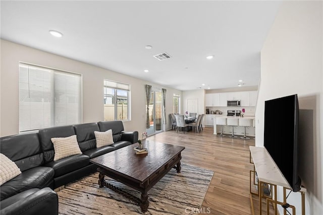 living room with light hardwood / wood-style flooring