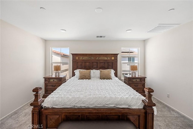 bedroom featuring multiple windows and light colored carpet