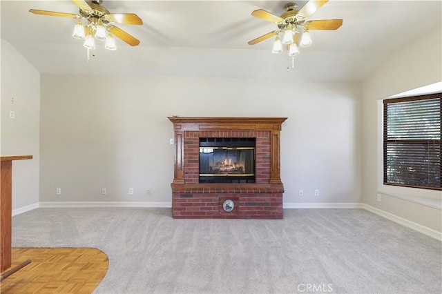 unfurnished living room with ceiling fan, light colored carpet, and a fireplace