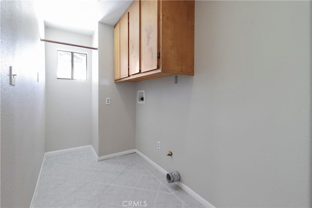 laundry area featuring cabinets, light tile patterned flooring, washer hookup, and hookup for a gas dryer