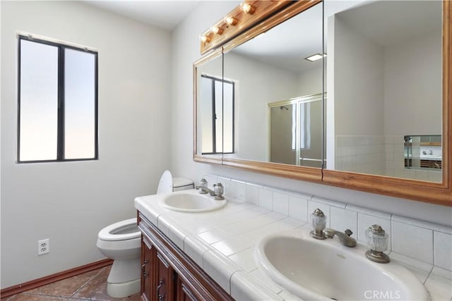 bathroom with walk in shower, vanity, toilet, and tile patterned flooring