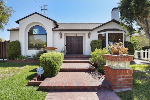 property entrance with a lawn