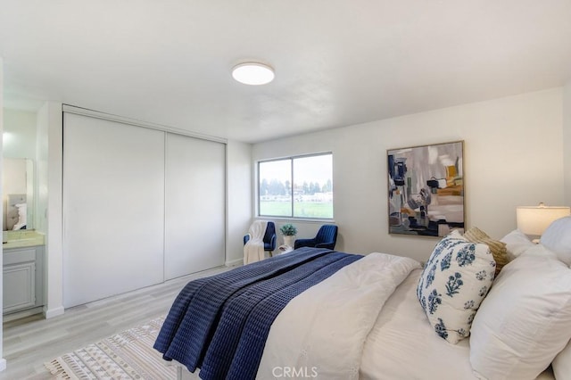 bedroom with a closet and light wood-type flooring