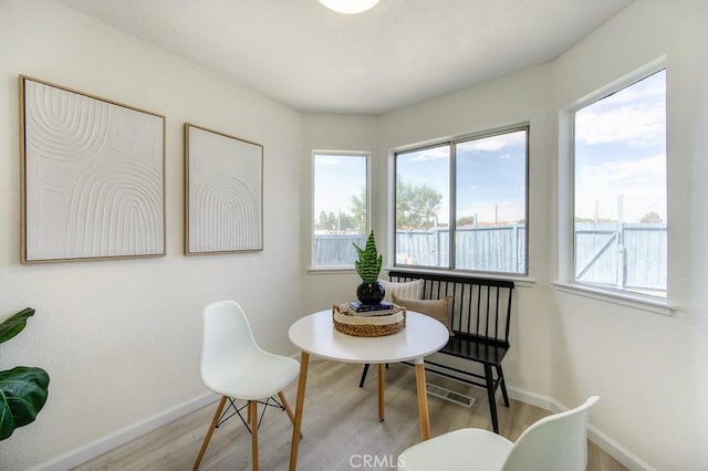 dining space with light hardwood / wood-style flooring