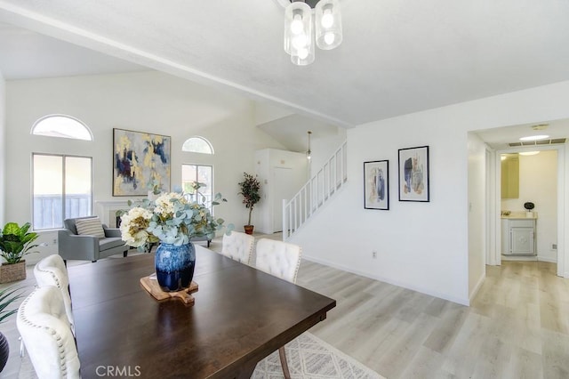 dining area featuring vaulted ceiling, a wealth of natural light, and light wood-type flooring