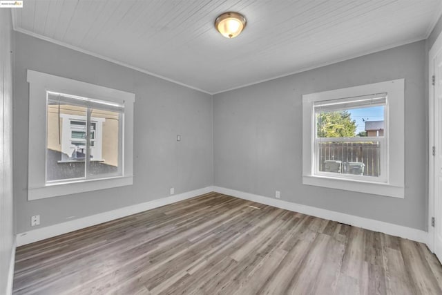 unfurnished room featuring ornamental molding, hardwood / wood-style floors, and wood ceiling