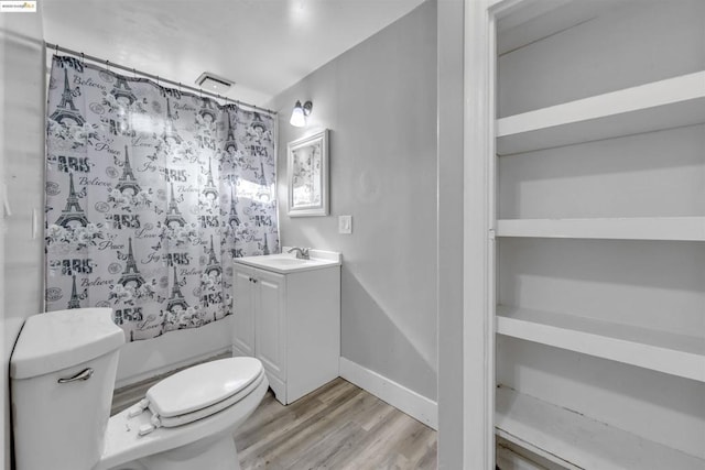 bathroom with hardwood / wood-style flooring, vanity, toilet, and a shower with shower curtain