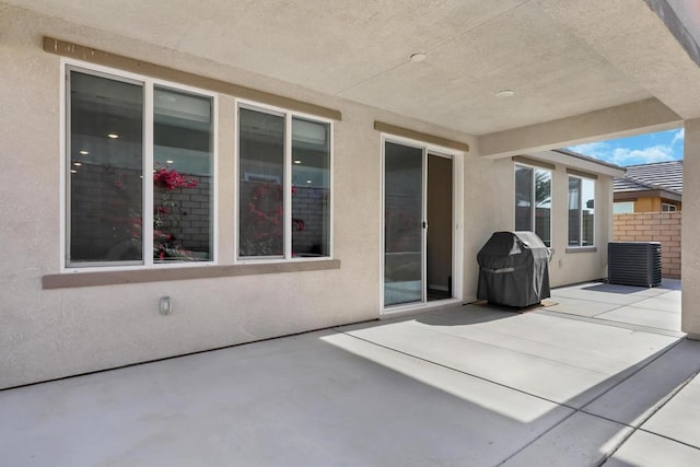 view of patio with area for grilling and cooling unit