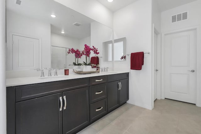 bathroom with walk in shower and vanity